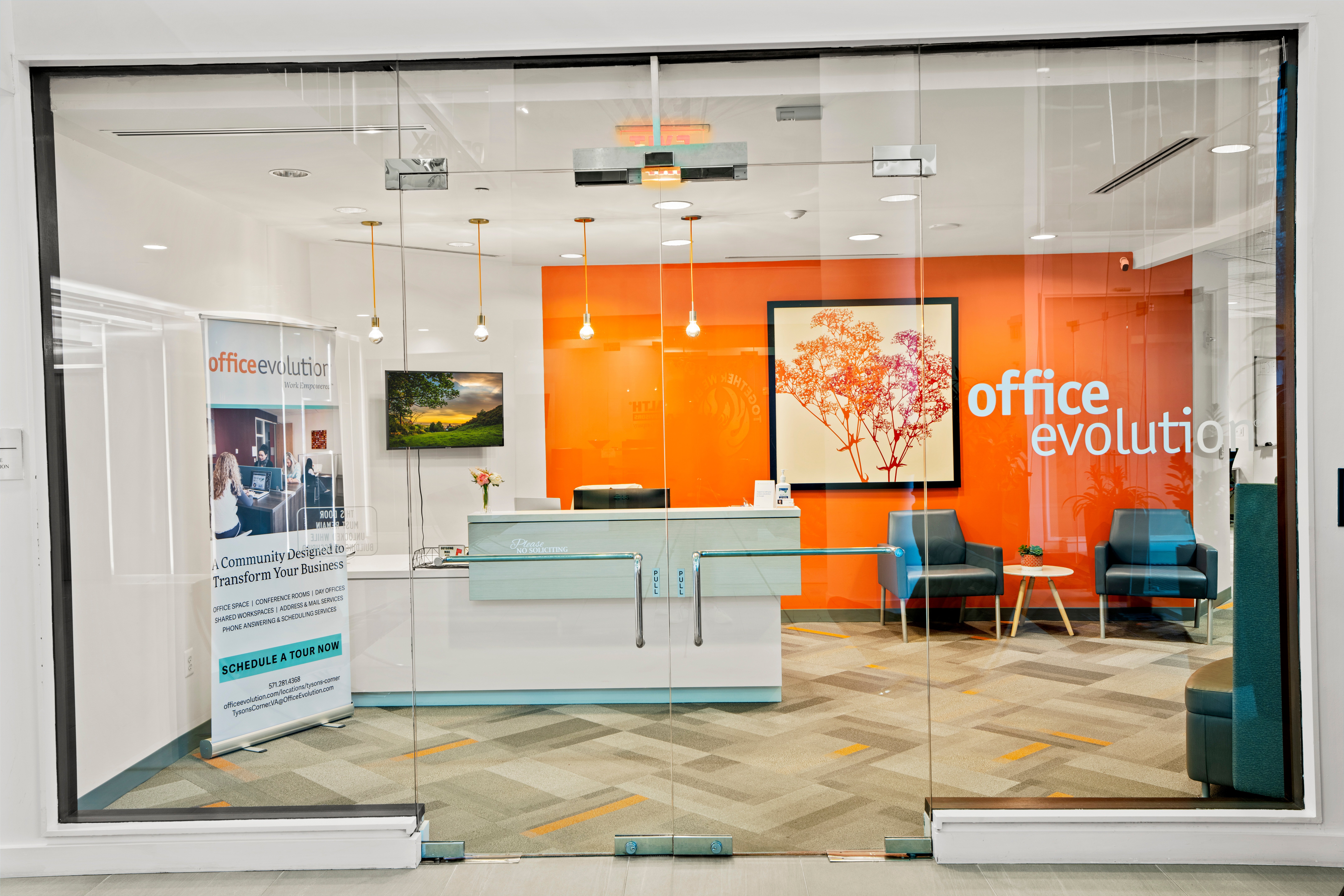 Glass-front office with orange accent wall