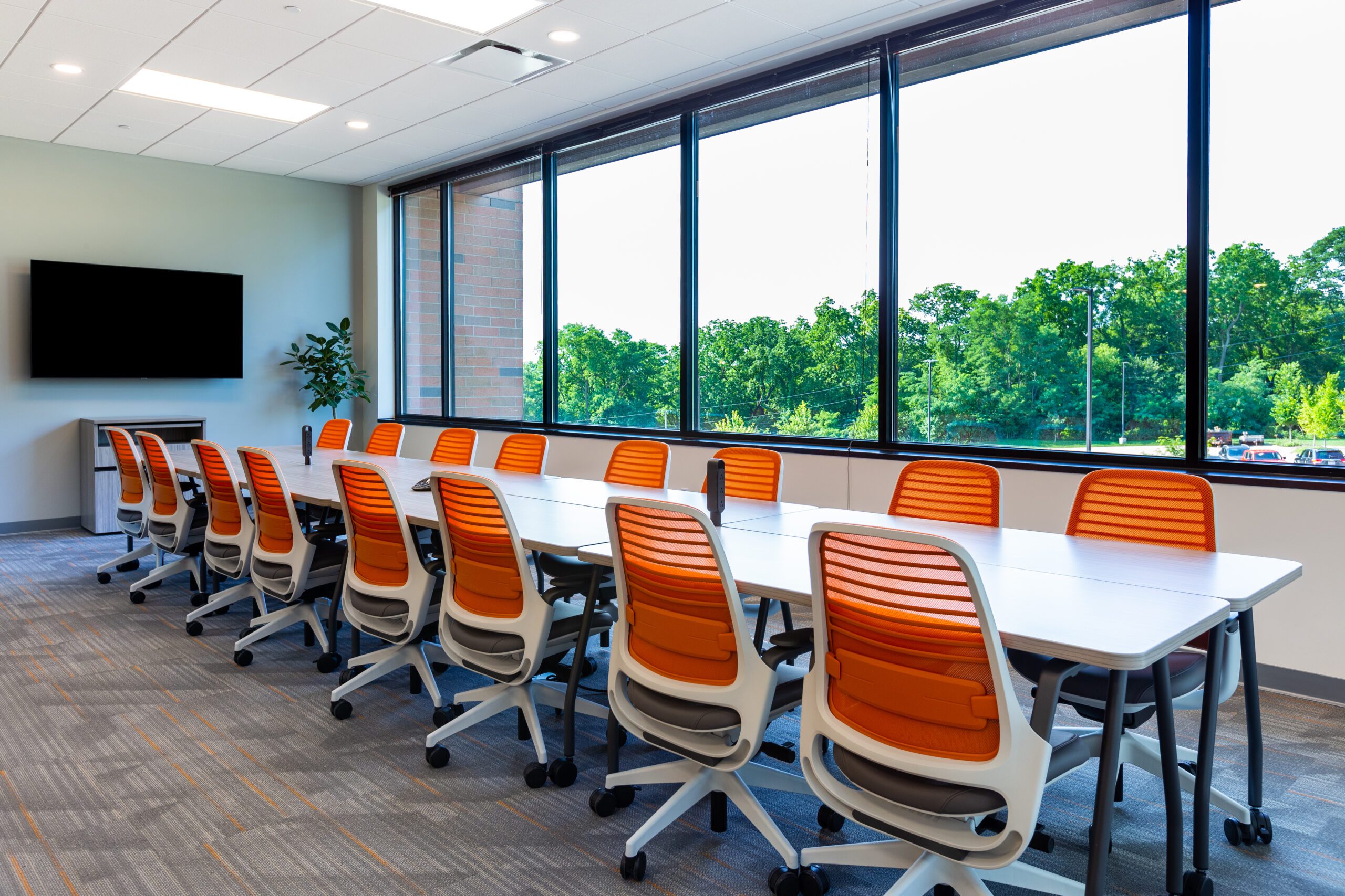 office evolution coworking franchise glass door|young colleagues sitting while working|office franchise meeting room